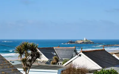 a view of the ocean from the roofs of houses at Gwithian, Sea Dream Beach Chalet in Gwithian
