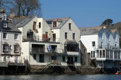 a group of houses next to the water at Fowey River Views in Fowey
