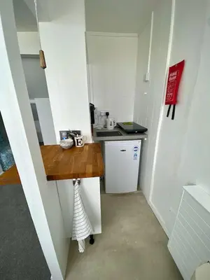 a small kitchen with a counter and a sink at Coast Accommodation in St Ives