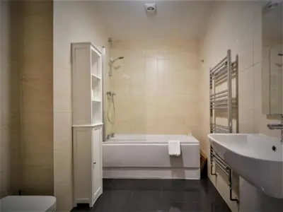 a bathroom with a tub and a toilet and a sink at SeaQuest 8 in Newquay