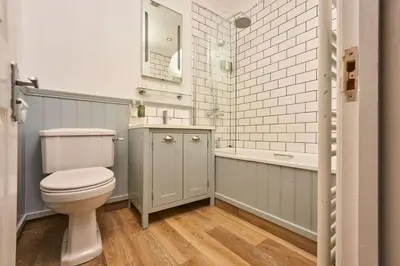 a bathroom with a toilet and a sink and a tub at Port William Inn in Tintagel