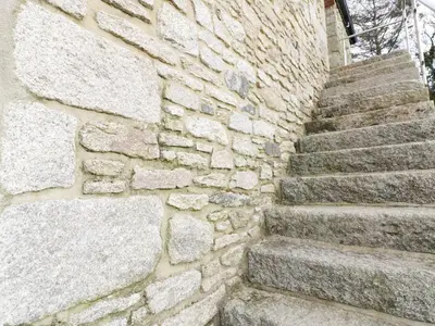 a stone wall with stairs in front of a building at Argal in Penryn