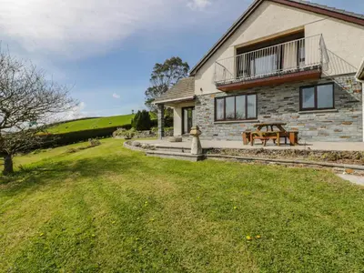 a house with a picnic table in front of it at Higher Kernick Farm in Launceston