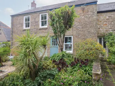 a stone house with a garden in front of it at 2 The Cottages in Ludgvan