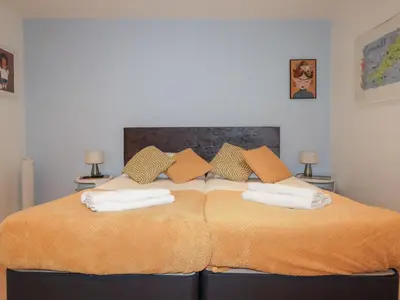 a bedroom with a large bed with two towels on it at Buena Vista in Newquay