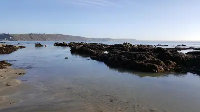 a group of rocks on the beach with the water at Romantic Hot Tub Breaks Marthys House Looe Polperro Talland Bay in Looe