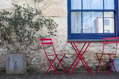two red chairs sitting in front of a window at Mannings Hotel in Truro