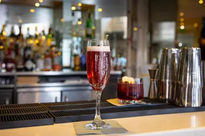 a glass of wine sitting on a bar at Mannings Hotel in Truro