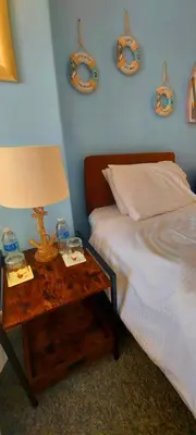 a bedroom with a bed and a table with a lamp at Sportsmans Valley Hotel in Liskeard