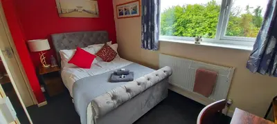 a small bedroom with a bed and a window at Sportsmans Valley Hotel in Liskeard