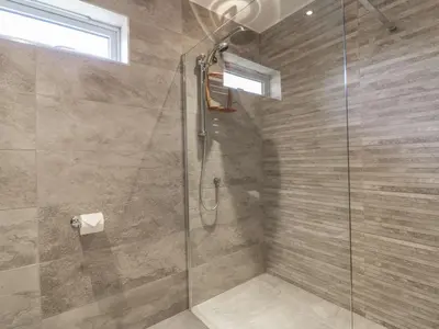 a bathroom with a shower with a glass door at Chy Lagen Hos in Newquay