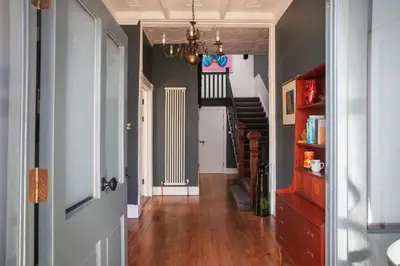 a hallway with a staircase in a house at Chelsea House Holiday Apartments in Falmouth