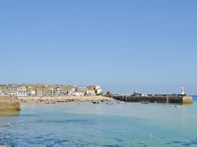 a view of a beach with boats in the water at Heatherstone in Illogan