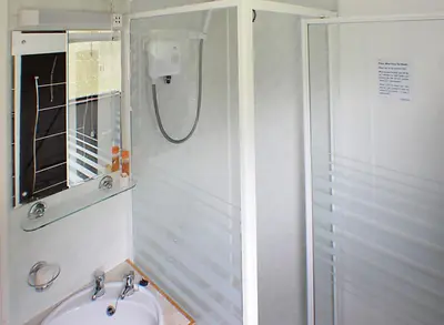 a bathroom with a shower and a sink at The Chalet at Mellowvean in St. Agnes