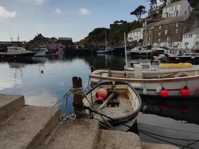 a group of boats docked in a harbor at The House on the Props in Polperro