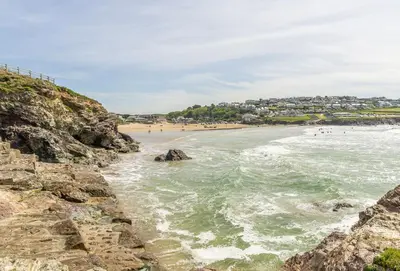 a view of a beach with people in the water at 12 Westward Flats in Polzeath