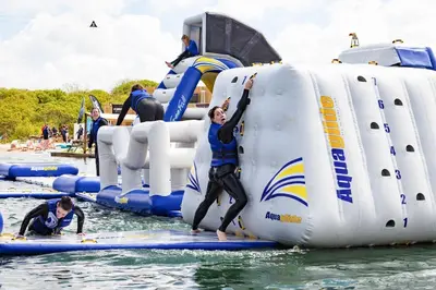a group of people in the water on an inflatable raft at Retallack Resort by Away Resorts in Padstow