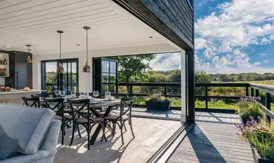 a patio with a table and chairs on a deck at Retallack Resort by Away Resorts in Padstow