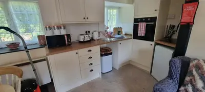 a kitchen with white cabinets and a counter top at No 4 Trelawney Apartment - Onsite Bar - Restaurant - Horse Riding in Menheniot