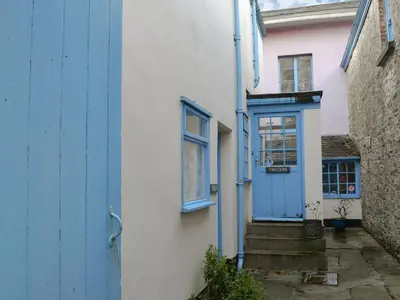 a house with a blue door and stairs in front at Isolda's - Ukc3905 in Lostwithiel