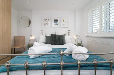 a bedroom with a bed with two stuffed animals on it at Number One - Stones Court in St Ives