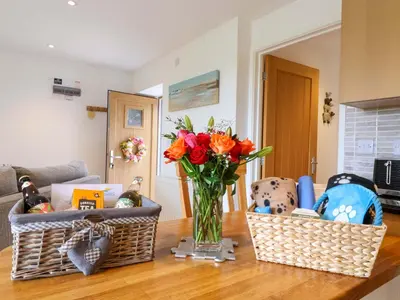 a vase of flowers sitting on a table with baskets at Cawsand in Saltash