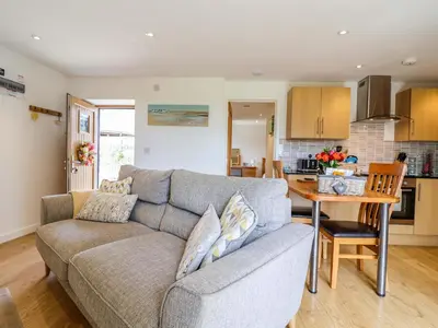 a living room with a couch and a table at Cawsand in Saltash