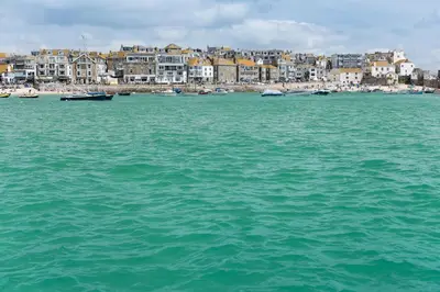 a large body of water with buildings in the background at Lifeboat Inn in St Ives
