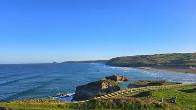 a view of the ocean with a path to a beach at Sand Dunes in Perranporth
