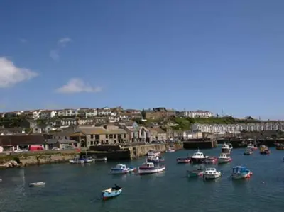 a group of boats are docked in a harbor at Pegs in Porthleven