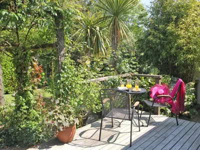 a table and chairs sitting on a wooden deck at Summer House in Helston