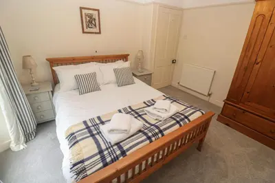 a bedroom with a bed with towels on it at Banneth in Mawgan