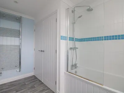 a bathroom with a shower with a glass door at St Ives View in Porthtowan