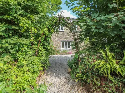 an archway in front of a stone house at Stocks Barn in Liskeard