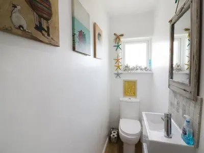 a bathroom with a toilet and a sink at Keelyn in Crantock