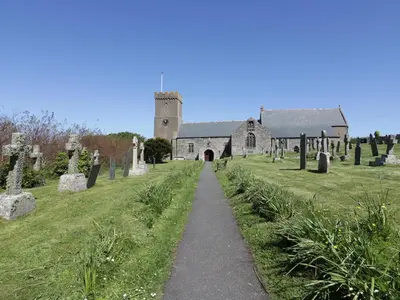 a church with a path leading to a cemetery at Keelyn in Crantock