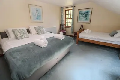 a bedroom with two beds with towels on them at Beggars Roost in Truro