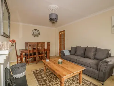 a living room with a couch and a table at Dune Haven in Truro