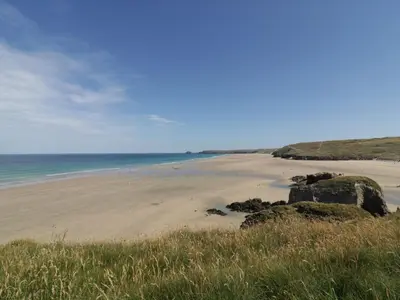 a beach with rocks and the ocean in the background at Dune Haven in Truro