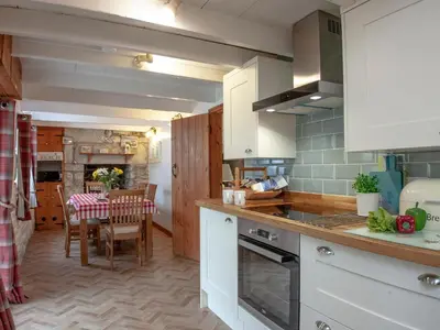 a kitchen with white cabinets and a dining room at Greenbank Farm in Saint Dennis