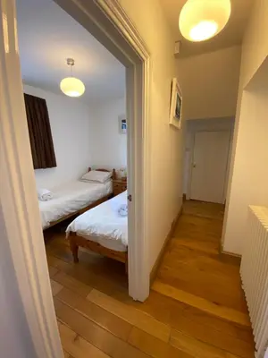 a hallway with two beds in a room at THE STONES St Ives Apartment Panoramic Harbour Views and Onsite Parking in St Ives