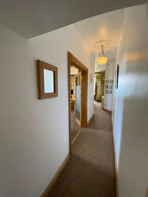 a hallway with a door leading to a room at THE STONES St Ives Apartment Panoramic Harbour Views and Onsite Parking in St Ives