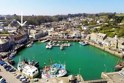a group of boats are docked in a harbor at TOWN CENTRE apartment with parking in Padstow