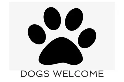 a black dog pawprint icon with the words dogs welcome at TOWN CENTRE apartment with parking in Padstow