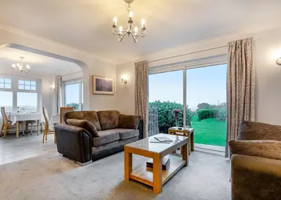 a living room with a couch and a table at Beacon Country House B & B & Luxury Shepherd Huts in St. Agnes