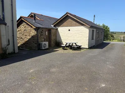a picnic table in front of a building at The Byre in Porthtowan