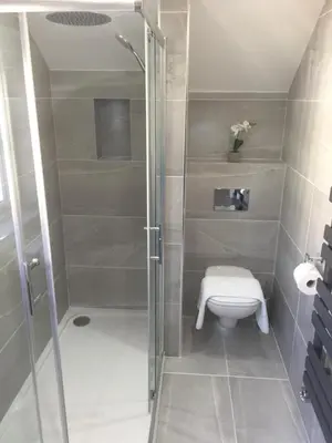 a shower stall with a toilet in a bathroom at Sunnyside Barn in Truro