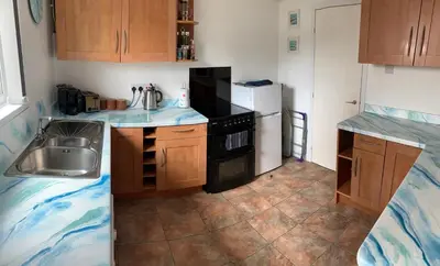 a small kitchen with a sink and a refrigerator at So Tranquil in Charlestown