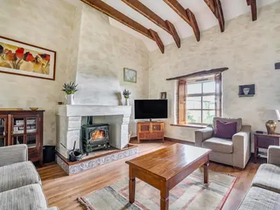 a living room with a fireplace and a tv at Provence-Uk12747 in Menheniot
