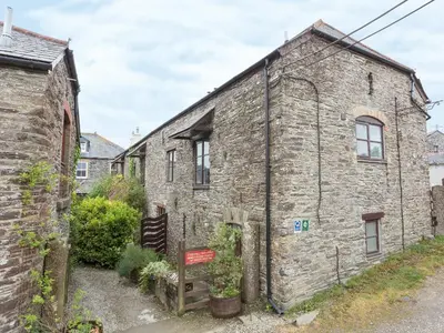 an old brick building with a sign in front of it at Moderno-Uk12748 in Menheniot